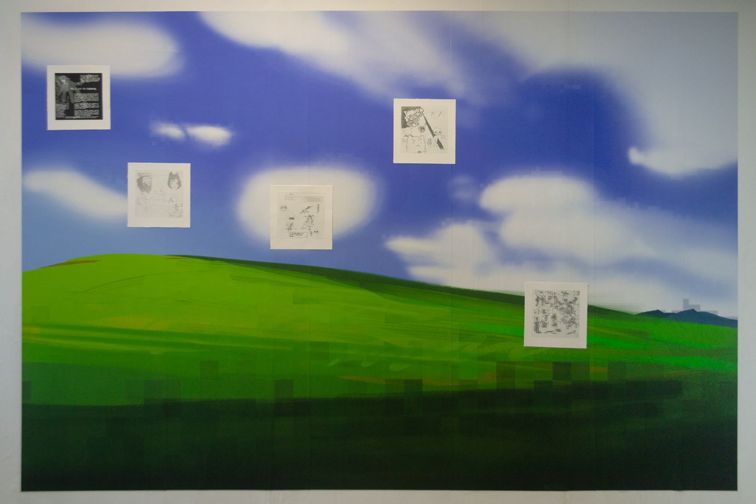 A photo of the wallpaper installation in the exhibition, with five etchings visible on it.